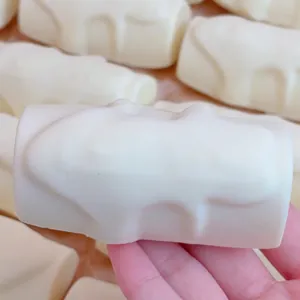 White cream stick squishy toy for stress relief featuring a slow rebound soft texture