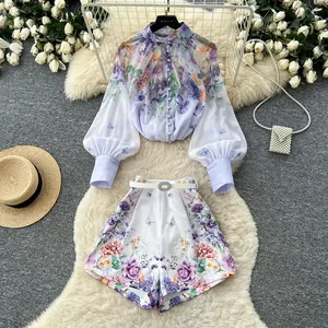 Detailed view of floral print two-piece set with lantern sleeve top and high waist shorts