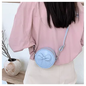 Sweet light blue round crossbody bag for girls featuring a cute 3D bow decoration detail