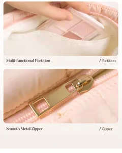 Detailweergave van interne scheidingswand en gouden rits op roze puffer make-up tas