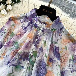 Elegant floral print court style blouse featuring a mock neck and white button detailing