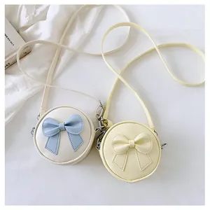 Two cute round mini crossbody bags for girls featuring sweet bow accents in soft colors