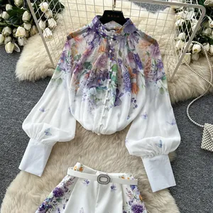 Floral print two-piece outfit with lantern sleeve blouse and high waist shorts details.