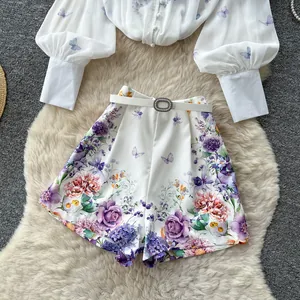 Detail of floral print 2-piece set with lantern sleeve blouse and high waist shorts