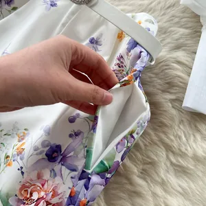 Close-up of side pocket detail on high waist floral print shorts for women.