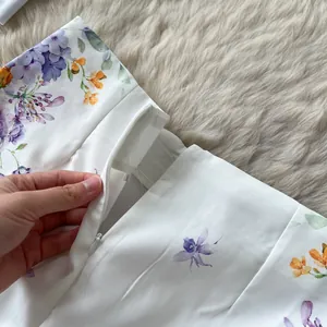 Close-up of the invisible zipper detail on palace style floral printed high-waist shorts