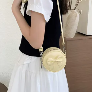 Sweet cream yellow round mini crossbody bag for girls with 3D decorative bow detail