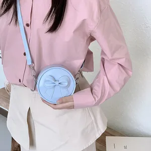 Sweet light blue round mini crossbody bag for girls featuring a large decorative bow