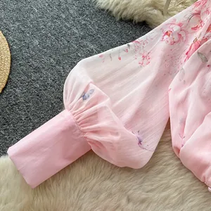 Detailed macro view of pink floral lantern sleeve with elegant pleated cuff design