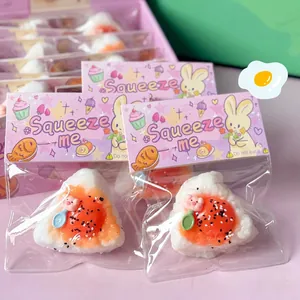 Close-up detail of cute egg yolk onigiri slow rebound squeeze toy in rabbit packaging