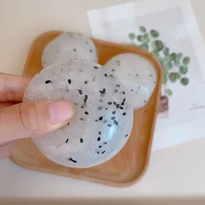 Close-up of translucent sticky rice ball squishy stress relief toy with bead texture