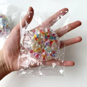 Colorful sensory stress ball filled with rainbow beads in clear plastic bag packaging