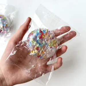 Detailed view of a handheld colorful gel bead stress ball inside a transparent plastic bag