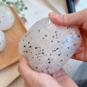 Close-up of translucent pitaya-styled squishy toy being squeezed by hands
