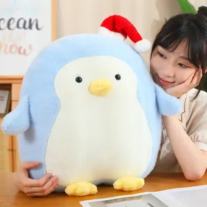 Soft and adorable blue penguin plush toy wearing a festive red Santa hat, perfect Christmas gift