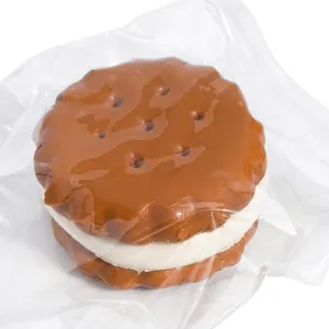 Detailed close-up view of a chocolate sandwich cookie squishy toy in vacuum packaging.