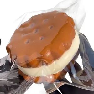 Close-up detail of a realistic chocolate sandwich biscuit squishy decompression toy in clear bag