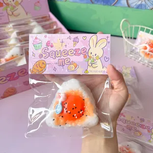Close-up of a slow rebound onigiri rice ball squishy toy in cute pink packaging