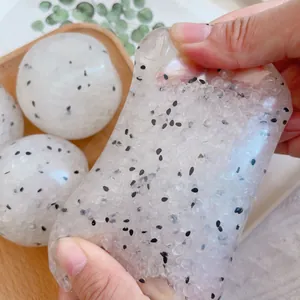 Detailed macro view showing the squishy texture of a rice ball fidget toy being stretched