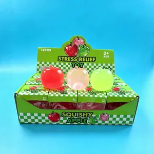 Juguetes antiestrés con forma de manzana de colores en una caja creativa de 12 unidades.