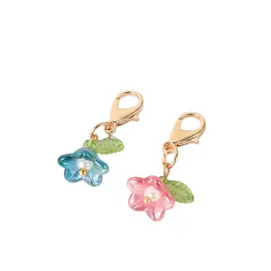 Pair of colorful iridescent flower charms with gold lobster clasps for bags and keys.