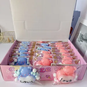 Display box containing cute pink and blue bear heart squishy toys with Love text