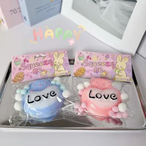 Detail of pink and blue heart bear squeeze toys with 'Love' text in a silver tray
