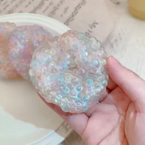 Close-up of translucent stress relief toy filled with colorful pearlescent beads