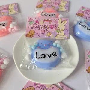 Adorable heart-shaped bear squeeze toy with 'Love' print in pink bunny packaging