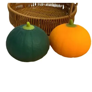 Two realistic pumpkin squishy toys in green and orange for slow rebound stress relief