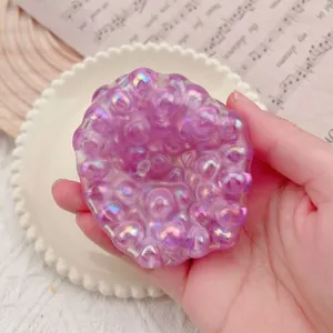 Macro detail of a purple bubble-textured squishy stress relief toy held in hand