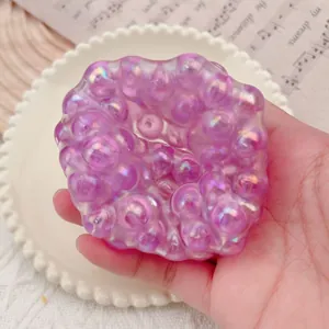 Close-up macro view of an iridescent purple bubble squishy toy for creative stress relief