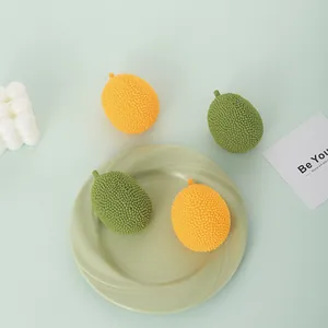 Realistic jackfruit stress relief squeeze toys presented on a green ceramic plate