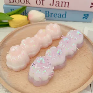 Detailweergave van roze en paarse kattenpoot squishy speeltje met glitters op dienblad
