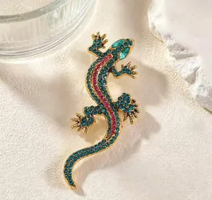 Close-up of vintage gecko brooch with vibrant blue and pink rhinestones