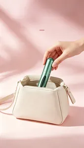 Compact 5ml matte green refillable perfume atomizer bottle being placed in a stylish bag.