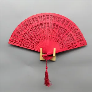 Elegant red hollow carved folding wood fan with tassel for classical weddings