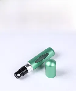Close-up of a 5ml matte green bottom-fill perfume atomizer for travel