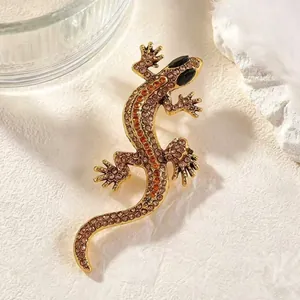 Vintage gold-toned lizard brooch encrusted with sparkling orange and brown rhinestones