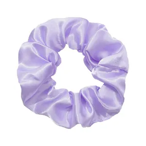 Detailed view of a light purple satin scrunchie with a glossy silk-like fabric texture