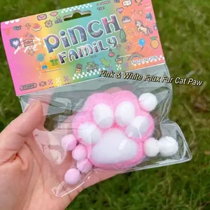 Flocked cat paw squishy decompression toy in pink and white for ultimate stress relief