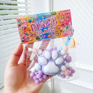 Détail d'un jouet à presser en patte de chat floquée violette dans un emballage coloré