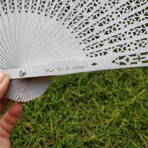Detail of laser engraved names on a silver hollow folding wooden wedding fan