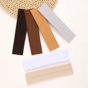 Detailed view of multicolor thin elastic sports headbands in soft neutral tones