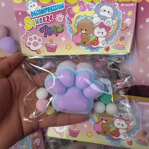 Close-up of a soft purple flocked cat paw squeeze toy in cute decorative packaging