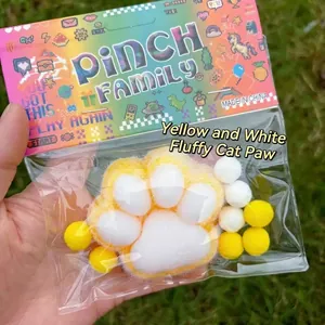 Soft yellow and white velvet-wrapped cat paw pinch squishy toy for stress relief