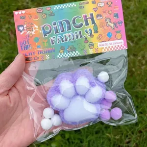 Purple and white flocked cat paw squishy toy for stress relief in retail packaging