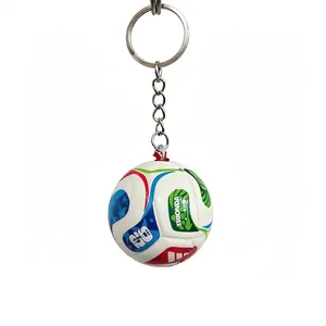 Close-up detail of a 3D soccer ball keychain with colorful printed graphics and ring.