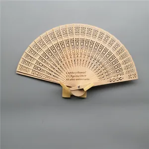 Detail of carved wooden fan with custom 40th anniversary engraving on stand