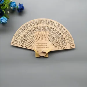 Detailed laser engraving on classic hollow-carved wooden folding fan for weddings.